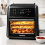 Chefman Air Fryer Oven sitting on a kitchen counter with crispy french fries inside